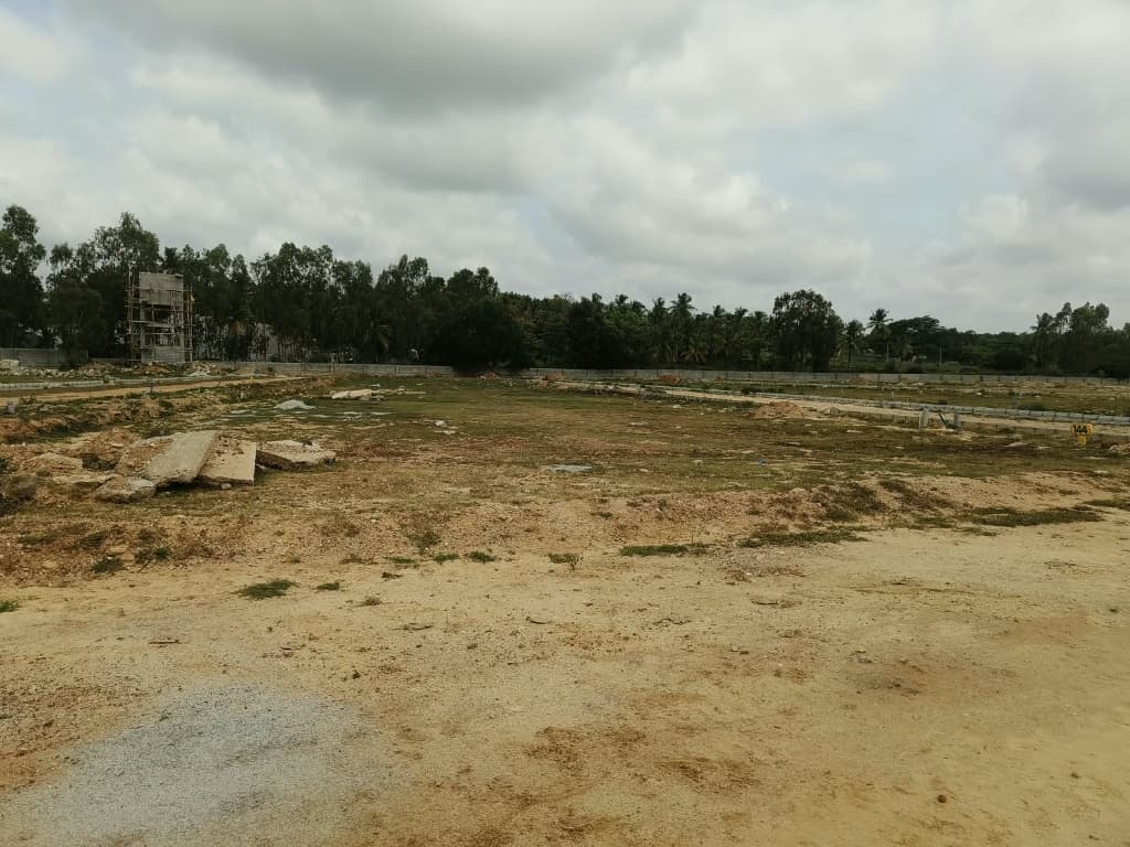 Overhead water tank structure and demarcated plot avenues at Suma Residency